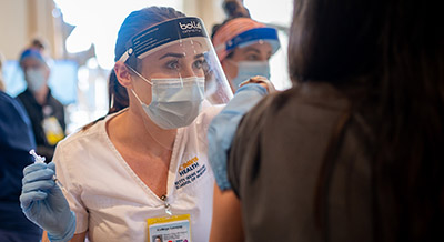 nursing student giving vaccine